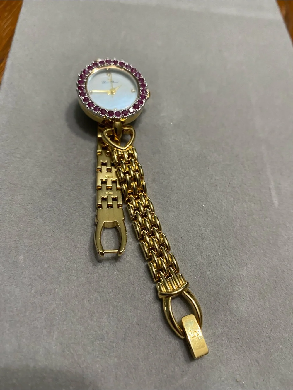 Lucien Piccard Gold-Tone Watch with Ruby Stone Bezel
